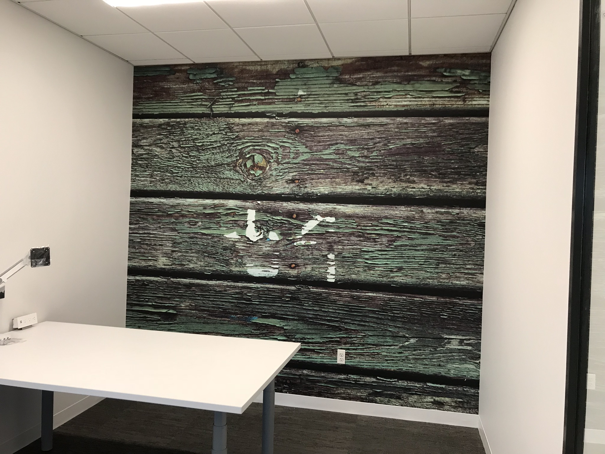 Wall mural of large wooden planks in an office created by SpeedPro 