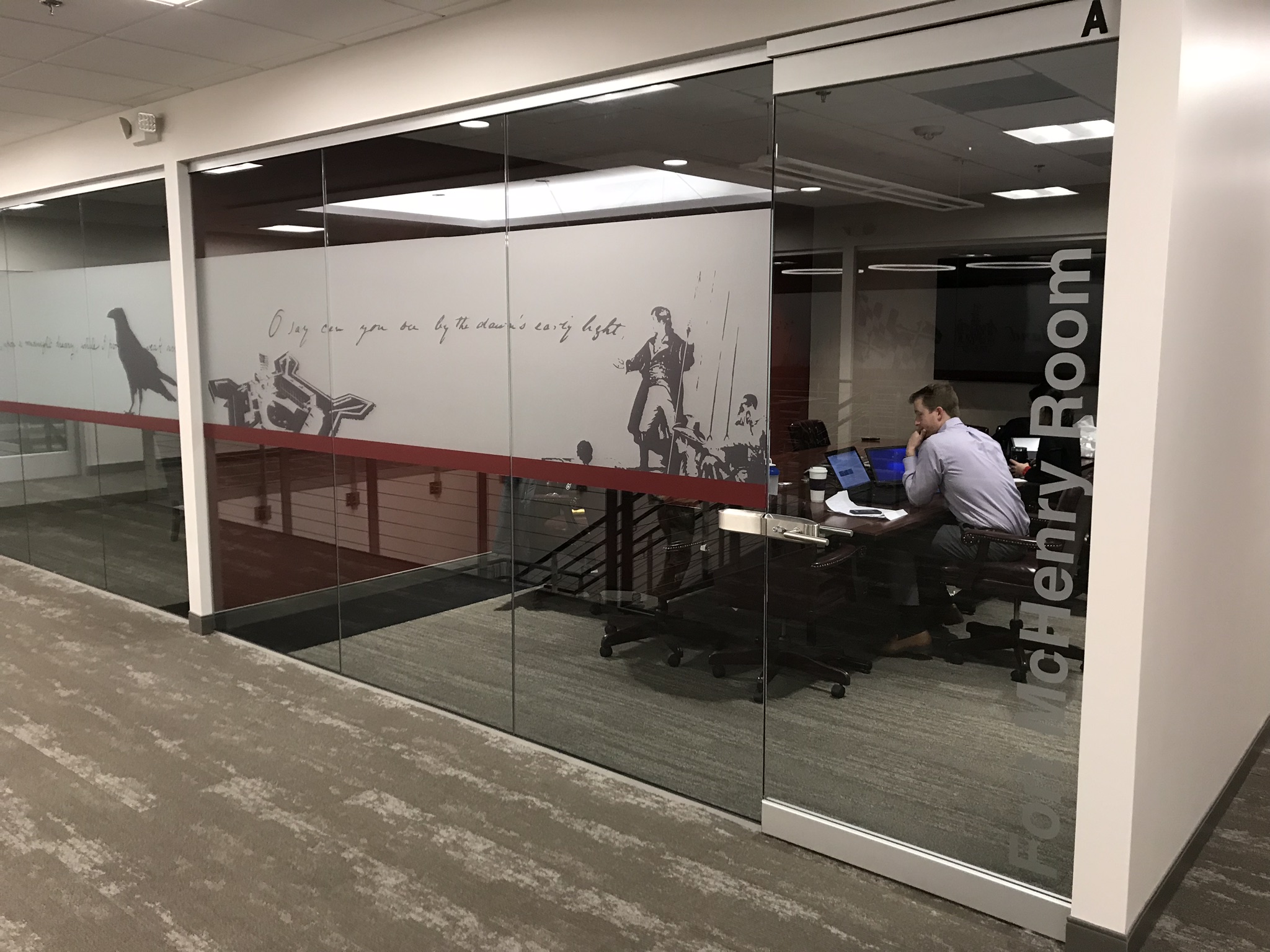Indoor sign on glass windows with images of Ford McHenry 