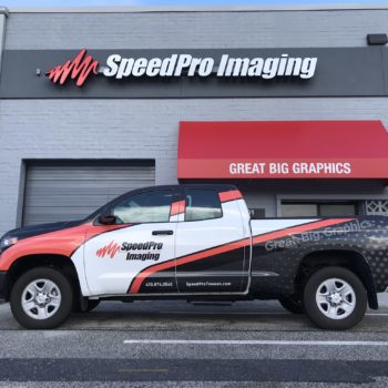 Outside of SpeedPro office featuring truck with vehicle wrap for SpeedPro 