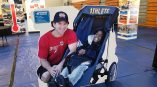 Man Posing With Child in Stroller