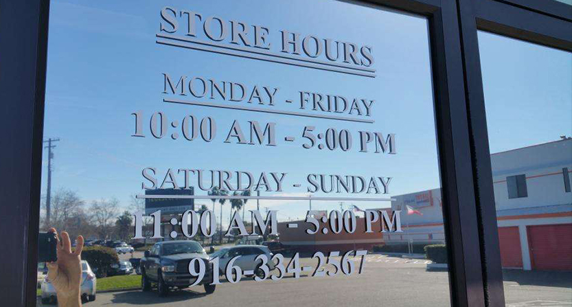store hours listed on a window