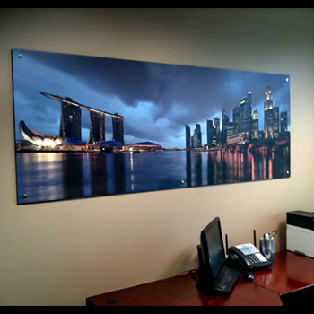 poster of city hanging on wall above desk
