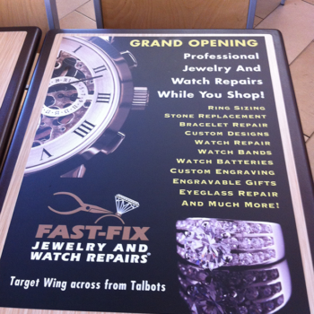 A table advertisement for the grand opening of a jewelry company.