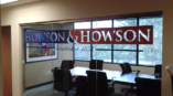 A large custom window graphic on the glass wall of a conference room for Howson & Howson.
