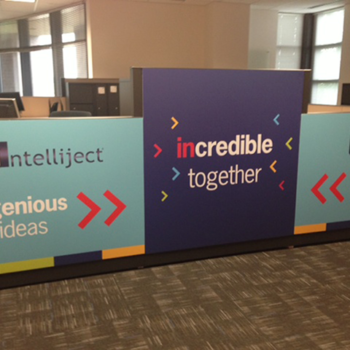 Wall graphics along cubical dividers in a business.