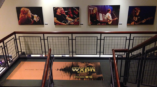 Images of musicians singing on a wall at a radio station.