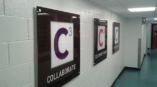 Three wall signs of business phrases.