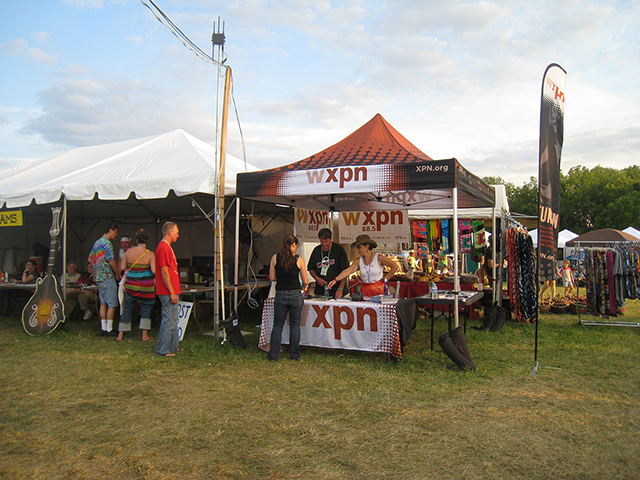 A line of business tents at a summer festival.
