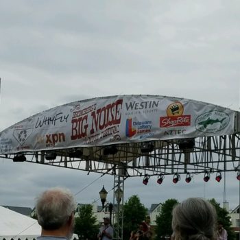 A banner made by SpeedPro of West Chester hung above a stage at a concert.
