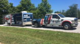 A pickup truck and trailer with matching vehicle wraps made by SpeedPro of West Chester.