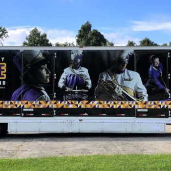 A semi-truck trailer with a custom designed vehicle wrap for the West Chester University marching band.