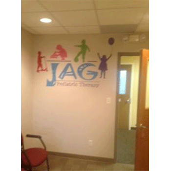 SpeedPro colorful indoor signage wall graphic for JAG pediatric therapy featuring children and logo
