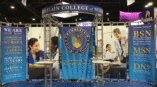 Trade show backdrop for Chamberlain College of Nursing with blue graphics and educational program highlights.