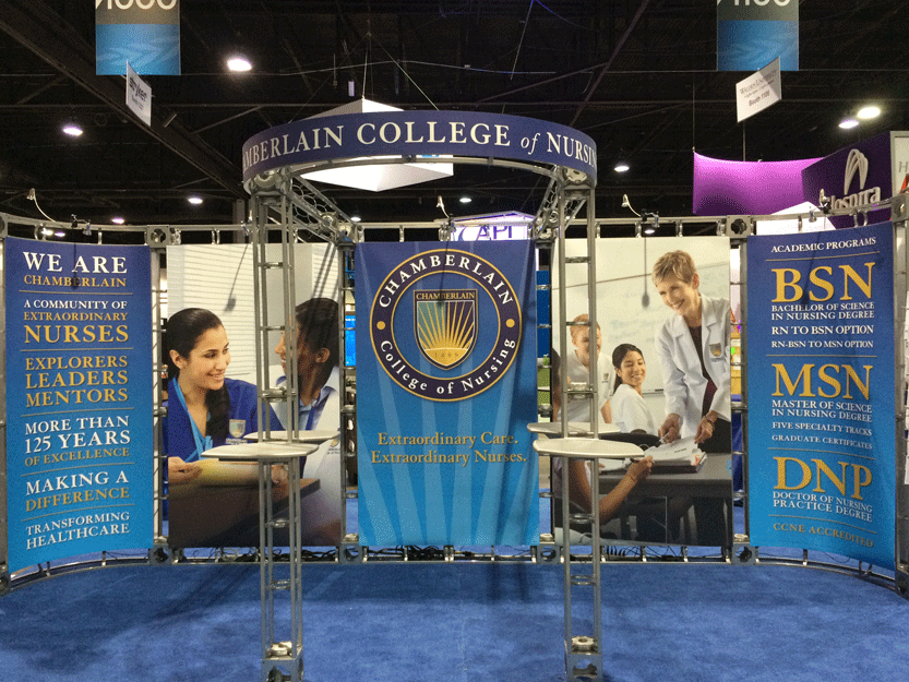 Trade show backdrop for Chamberlain College of Nursing with blue graphics and educational program highlights.