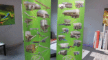 Retractable banners featuring various agricultural equipment graphics on green background in display area.