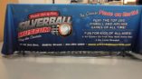 Table throw graphic for Silverball Museum showcasing vibrant branding and event information at a gaming convention.