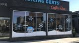 Frosted window graphics featuring snowflakes and a polar bear design for Dancing Goats Coffee Bar.
