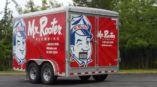 Full trailer wrap for Mr. Rooter Plumbing featuring bright red graphics and a cartoon mascot on both sides.