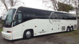 Full bus wrap for Ultimate Arrival featuring large branded graphics on a white background.
