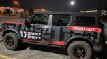 Full vehicle wrap for Jimmy John's with bold black and red graphics showcasing the slogan 'Freaky Fast.'