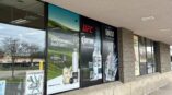 Window graphics showcasing various brands, including Cuervo and 1800 Cristalino, on a retail storefront.