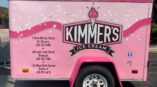 Partial trailer wrap for Kimmer's Ice Cream featuring pink background, logo, and business contact information.