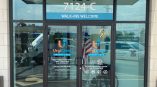 Urgent care storefront with glass doors displaying UrgiClinic logo, hours, and 'Walk-Ins Welcome' text in Chicago.