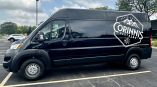 Partial van wrap featuring Corinnis Partners logo and mountain design on a black delivery van.