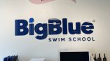 Dimensional wall lettering for Big Blue Swim School featuring a playful welcome graphic with a bird.