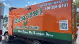 Full truck wrap for College Hunks featuring orange and green graphics with contact information and a QR code.