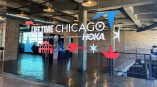 Window graphics for the Lifetime Chicago Marathon + 5K, featuring vibrant red and blue motifs, displayed on a glass wall.
