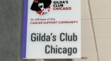 Acrylic sign for Gilda's Club Chicago featuring logo and community support message.