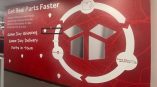 Wall mural featuring red background with white graphics and text for 'Parts in Town' emphasizing same-day shipping and delivery.