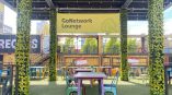 Hang banner for GoNetwork Lounge displayed in a vibrant outdoor seating area with greenery and colorful chairs.