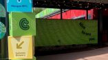 Directional signage stack featuring 'Morgan MFG' and 'Guinness Brewery' with vibrant branding in a colorful outdoor space.