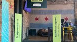 Hanging sign for Google & Salesforce success hub with two vertical wayfinding displays in green.