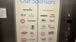 Elevator door graphic with colorful floral design, featuring sponsor logos and 'Thank You to Our Sponsors' text.