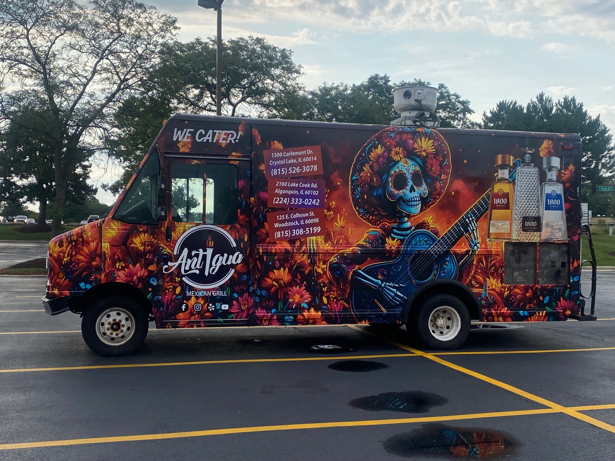 Full vehicle wrap for Antigua Mexican Grill featuring vibrant floral designs and a skeleton guitarist in a colorful mural.