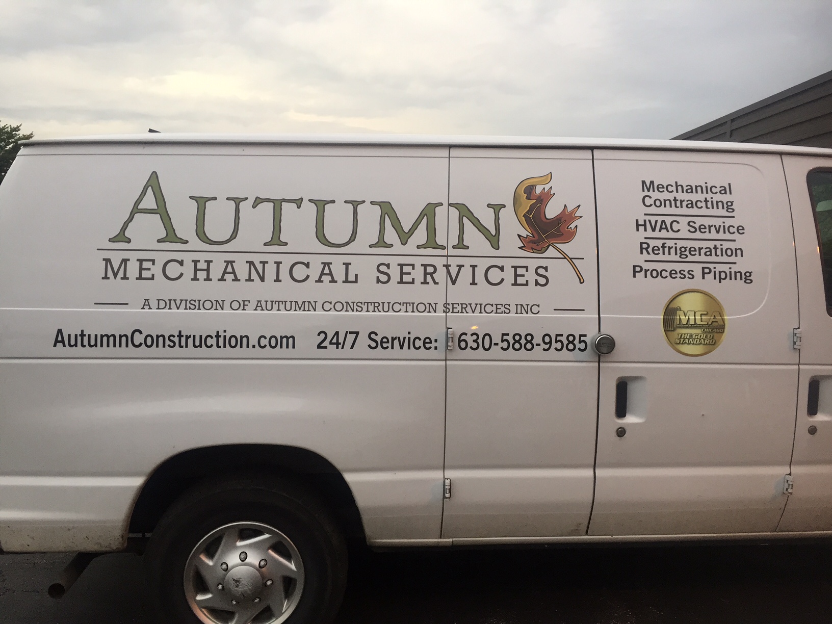 Van graphics for Autumn Mechanical Services displaying contact information, services, and logo on a white van.
