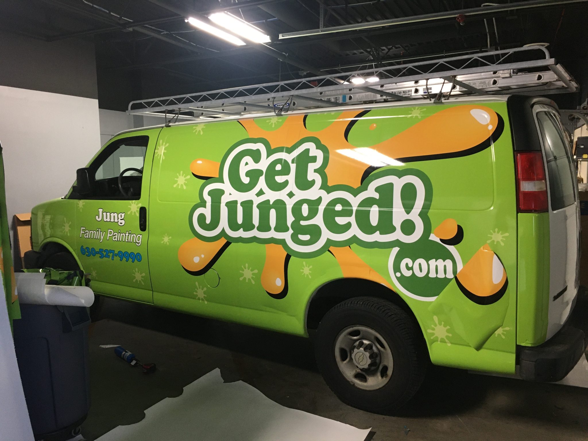 Full van wrap for Jung Family Painting featuring vibrant green and orange colors with playful graphics.