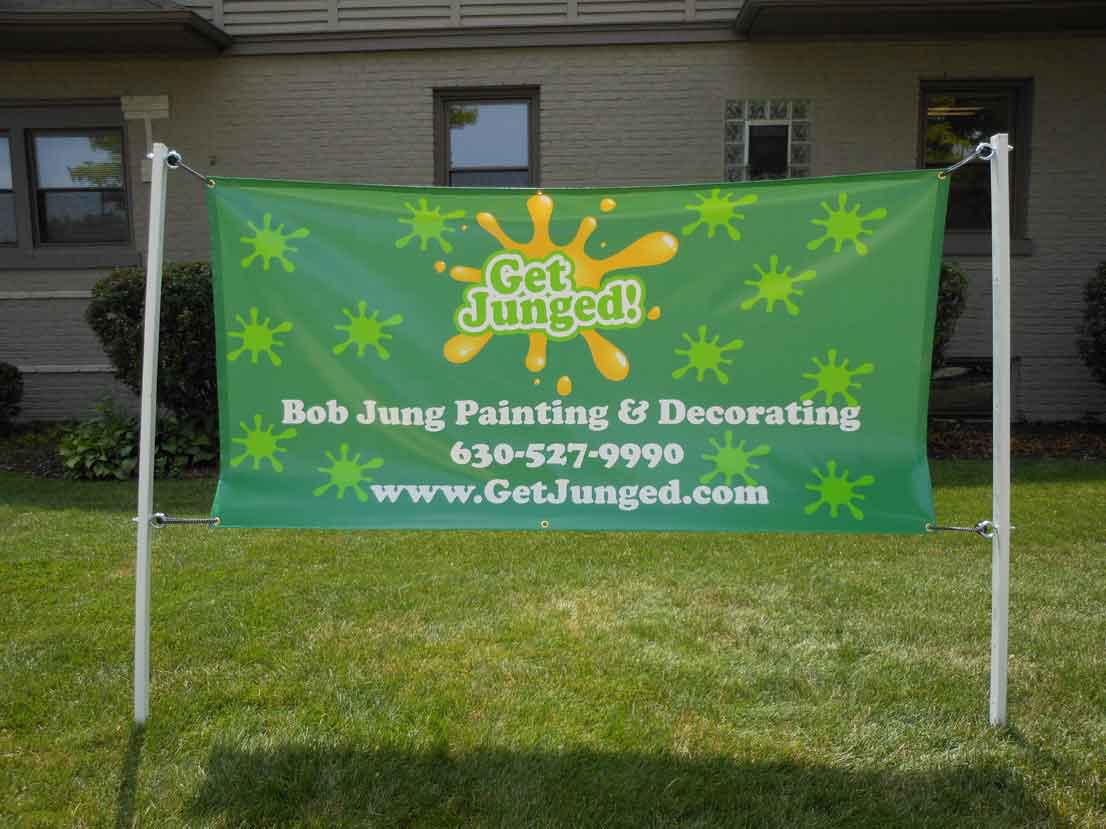 Outdoor banner for Bob Jung Painting & Decorating, featuring green background with paint splash graphics and contact information.