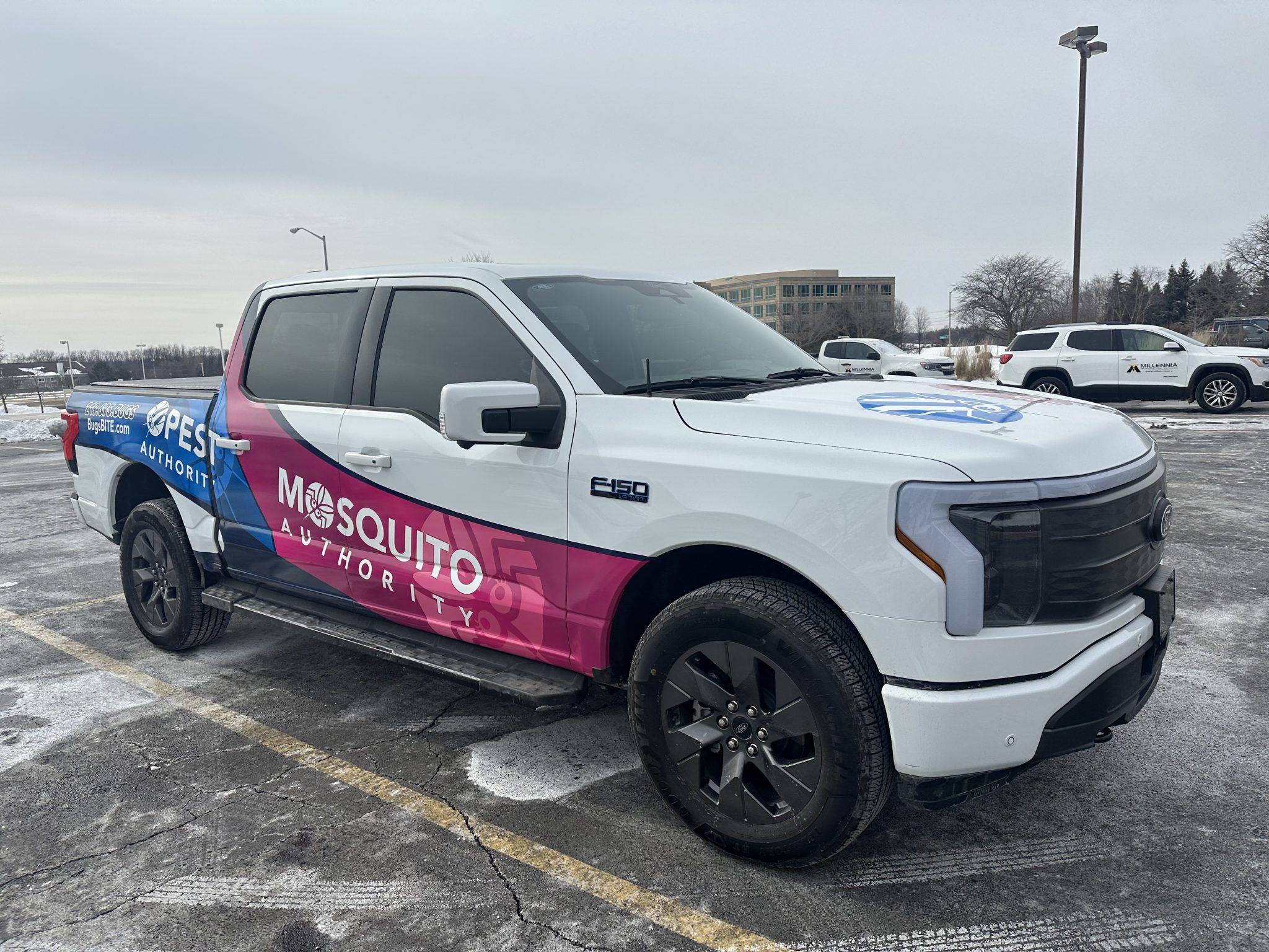 Full truck wrap for Mosquito Authority featuring a gradient design in blue, pink, and white colors.