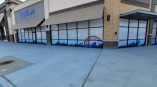 Frosted vinyl window graphics for Big Blue Swim School featuring colorful waves and a rainbow design.