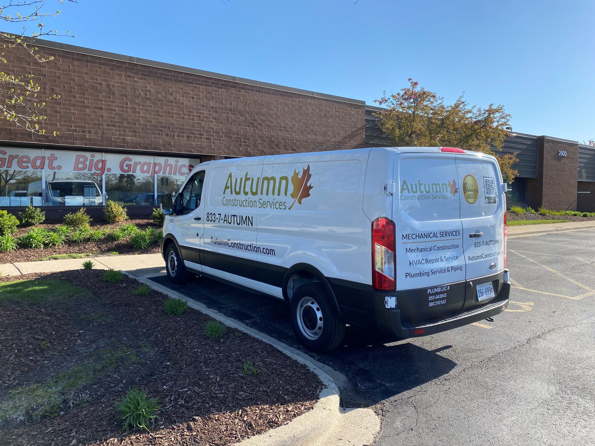 Partial vehicle wrap on commercial service van showing branded graphics for local business