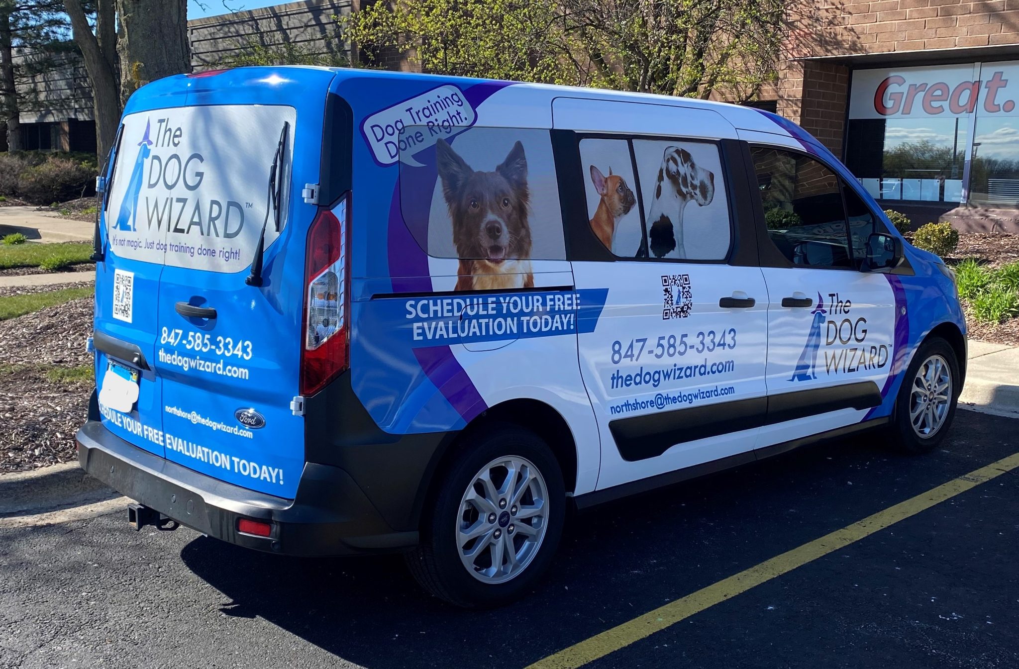 Full Ford Transit Connect wrap with colorful branded graphics for a dog training business, installed at SpeedPro Windy City