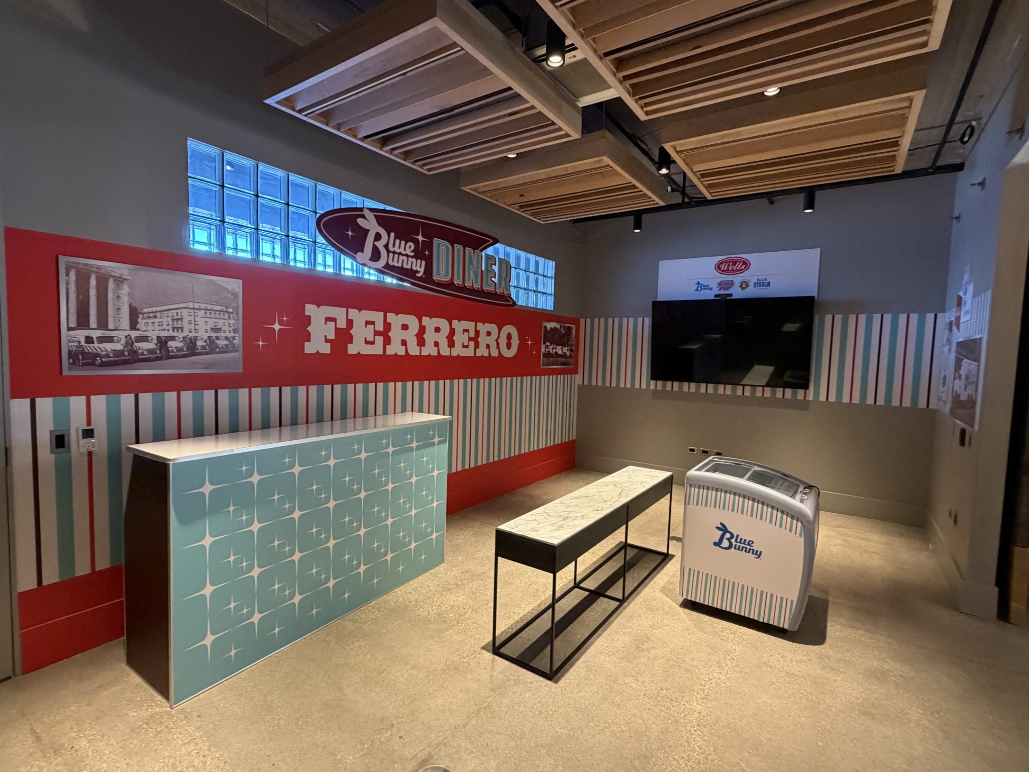 Retro diner venue takeover for a global confectionery brand's 80th anniversary activation with wall murals, wrapped counter, and branded freezer, installed by SpeedPro Windy City