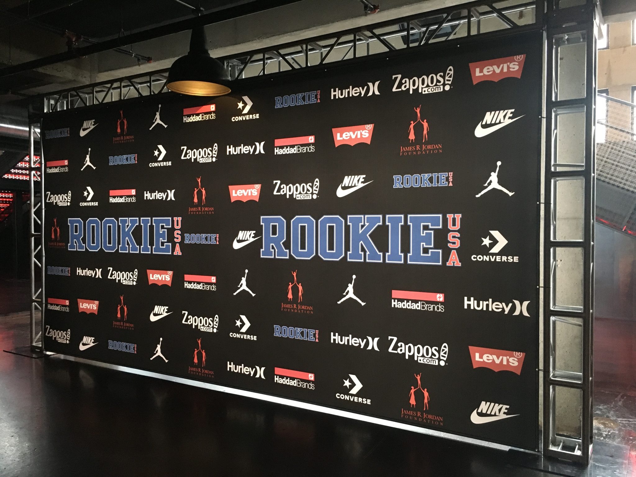 Truss-mounted step and repeat media wall with national brand logos produced by SpeedPro Windy City for an NBA All-Star Weekend event in Chicago