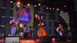 Kids Corner Music Festival banner with band playing