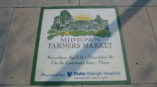 Midtown Farmers Market sign on a wall