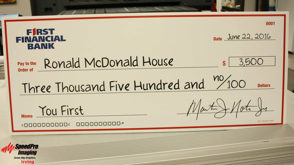 First Financial Bank giant check to Ronald McDonald House
